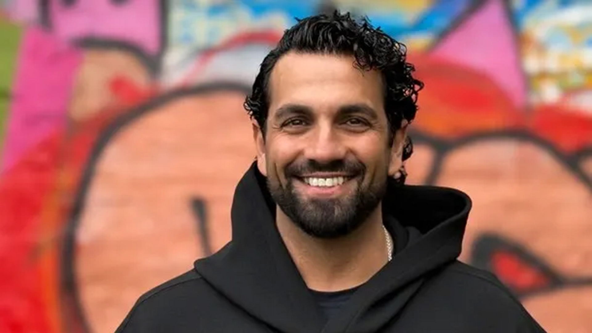 Nadim Ghazale är i 40-årsåldern. Han har mörkt lockigt hår som är kammat bakåt och helskägg. Han ler stort mot fotografen, bakom honom finns en vägg med graffitimålning. Nadim är klädd i en svart hoodie och under syns en svart t-shirt och en halslänk. 